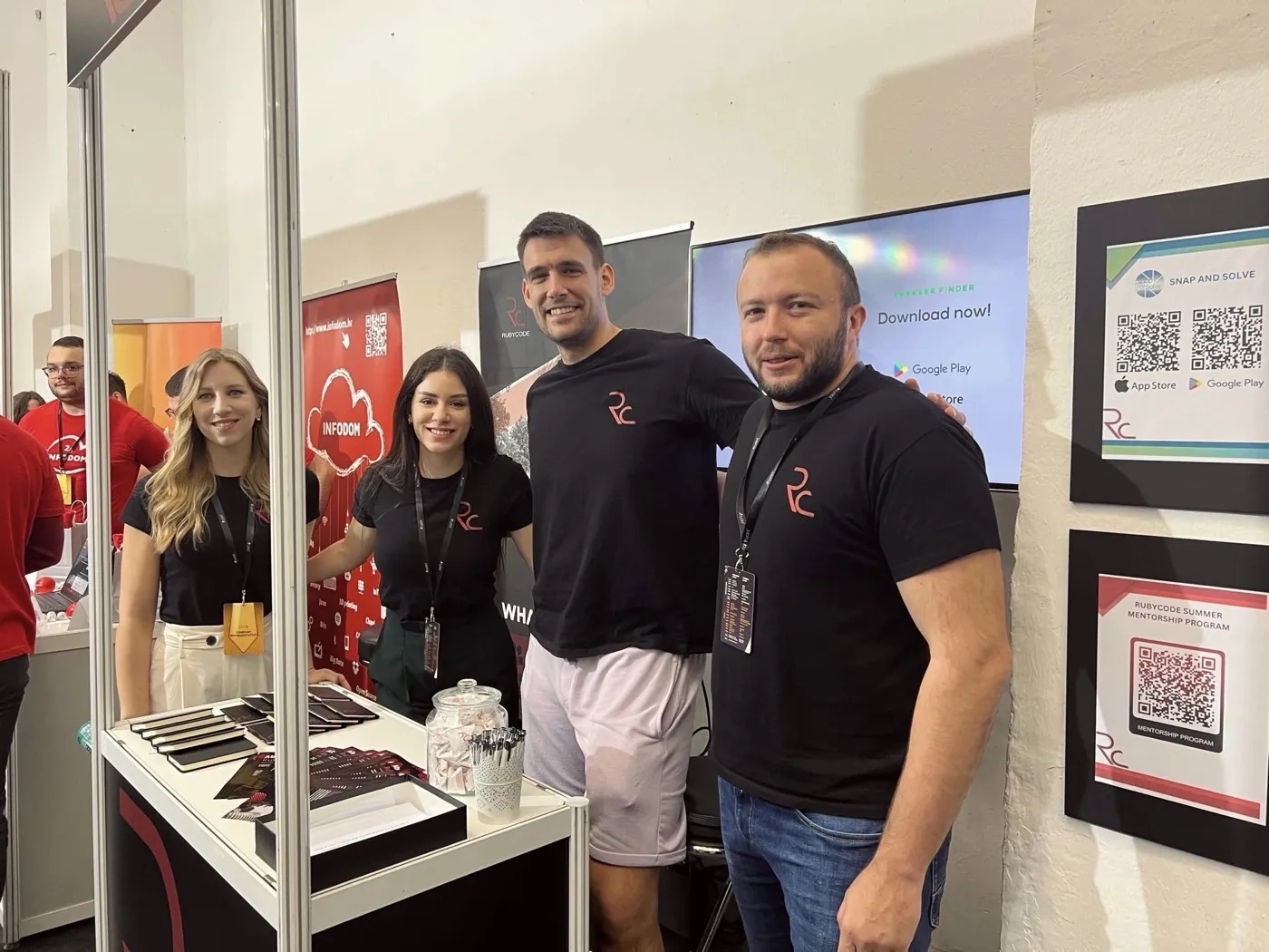 Rubycode team members at the company stand at a tech conference